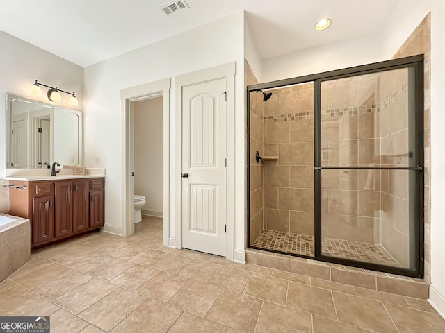 full bathroom with visible vents, toilet, a stall shower, tiled bath, and vanity