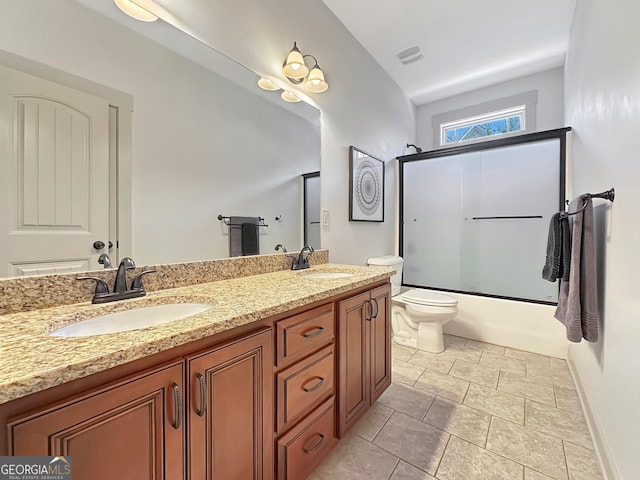 bathroom with a sink, visible vents, toilet, and double vanity