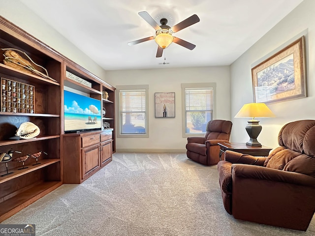 living area with light carpet and a ceiling fan