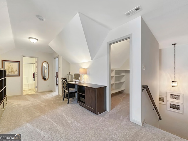 office space with lofted ceiling, baseboards, visible vents, and light carpet