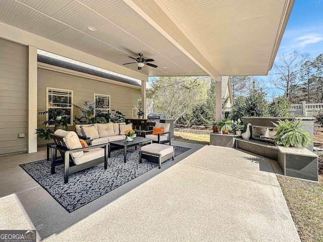 view of patio with area for grilling, an outdoor hangout area, a ceiling fan, and fence