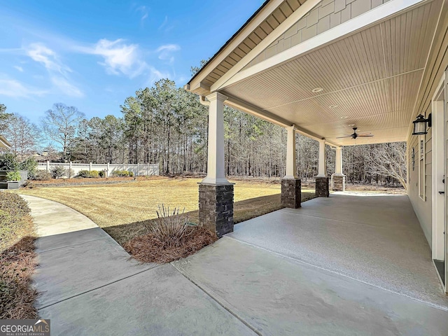 view of patio with fence and ceiling fan