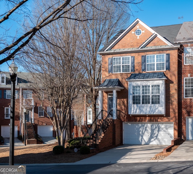 view of front of property featuring brick siding, a garage, and driveway
