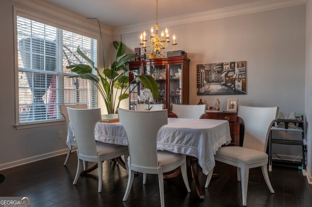 dining room with a healthy amount of sunlight, an inviting chandelier, wood finished floors, and ornamental molding