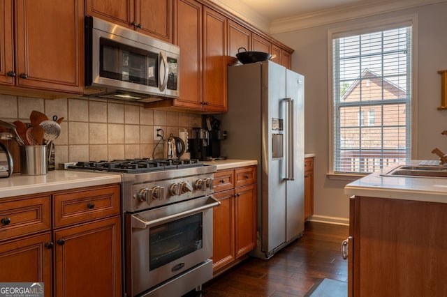 kitchen with high end appliances, brown cabinetry, and crown molding