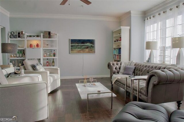 living room featuring ornamental molding, baseboards, ceiling fan, and wood finished floors