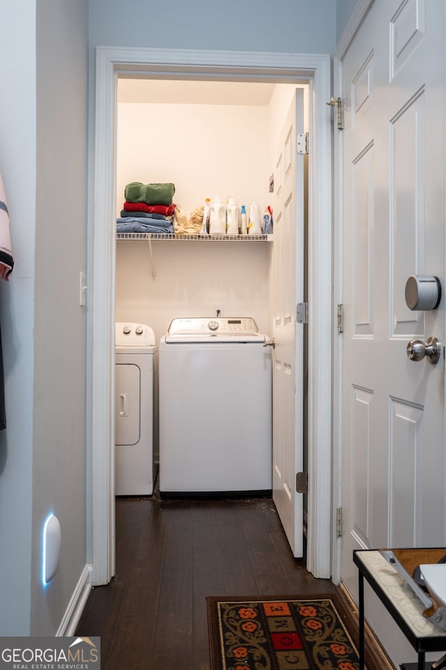 clothes washing area with washing machine and clothes dryer, laundry area, and dark wood finished floors