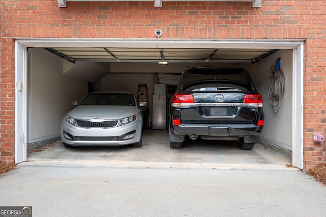 garage featuring concrete driveway