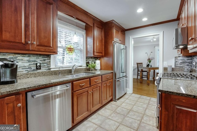 kitchen with ornamental molding, a sink, dark stone countertops, tasteful backsplash, and appliances with stainless steel finishes