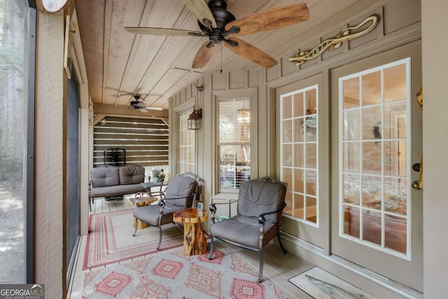 sunroom / solarium with wooden ceiling and ceiling fan