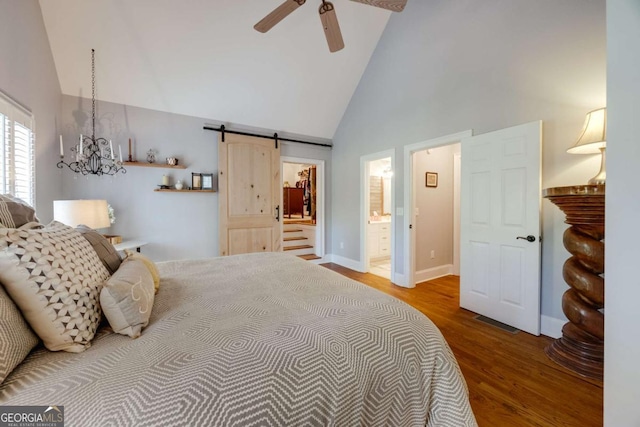 bedroom featuring visible vents, a barn door, ensuite bathroom, wood finished floors, and high vaulted ceiling