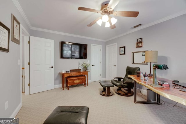 carpeted home office featuring crown molding, visible vents, baseboards, and ceiling fan