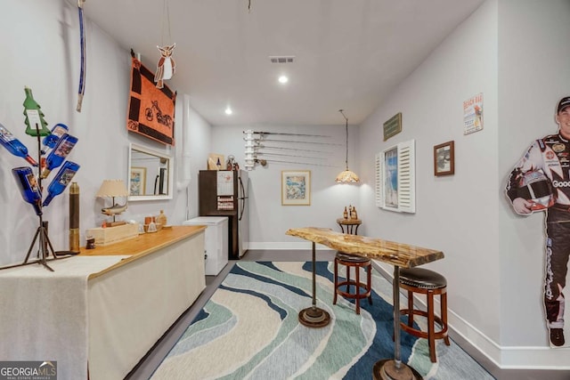 kitchen with recessed lighting, baseboards, visible vents, and freestanding refrigerator