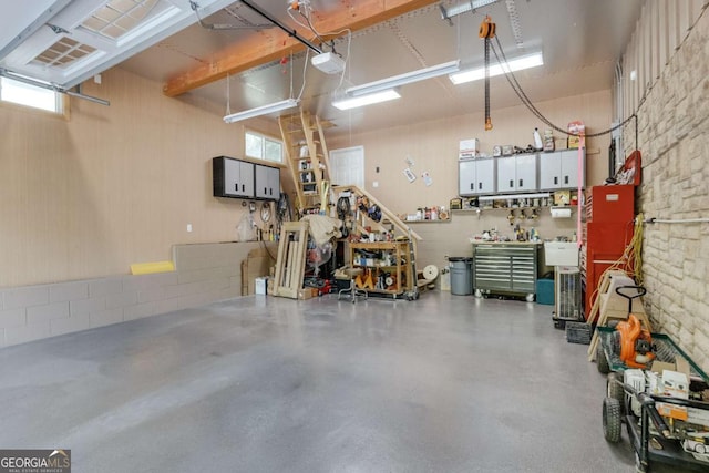 garage with a workshop area and a garage door opener