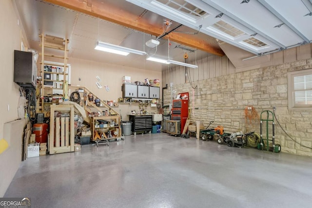 garage featuring a workshop area and a garage door opener