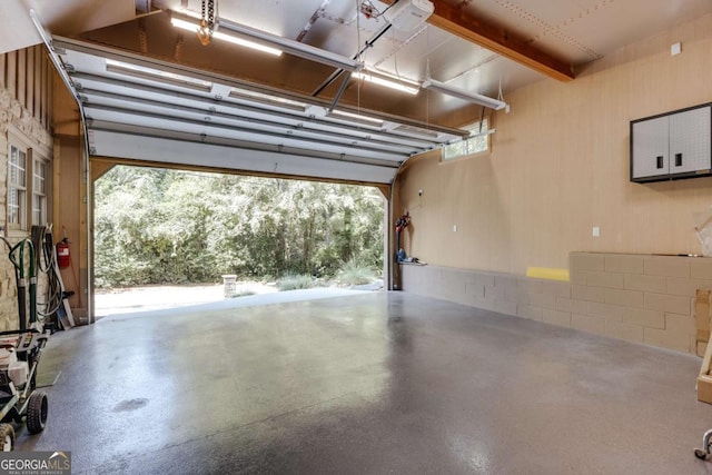 garage with concrete block wall