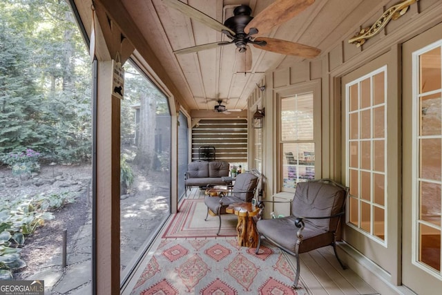 sunroom with wooden ceiling and ceiling fan