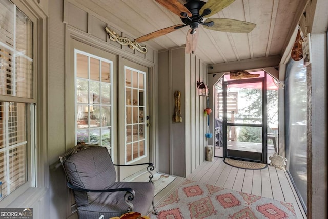 sunroom / solarium with wooden ceiling and a ceiling fan