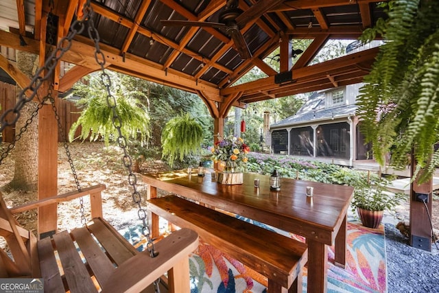 view of patio / terrace with a gazebo and a sunroom