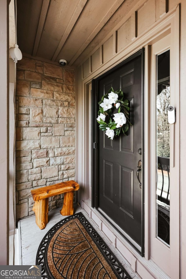 view of exterior entry featuring stone siding