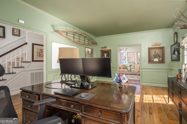 office featuring hardwood / wood-style floors, visible vents, ornamental molding, and a decorative wall