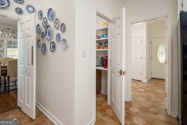 corridor featuring baseboards