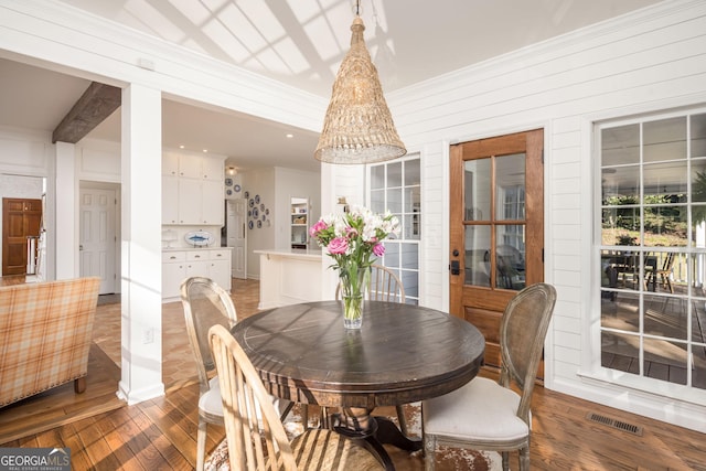 dining space featuring wood finished floors and visible vents