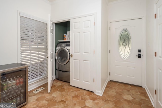 washroom with washer / clothes dryer, a healthy amount of sunlight, ornamental molding, and laundry area