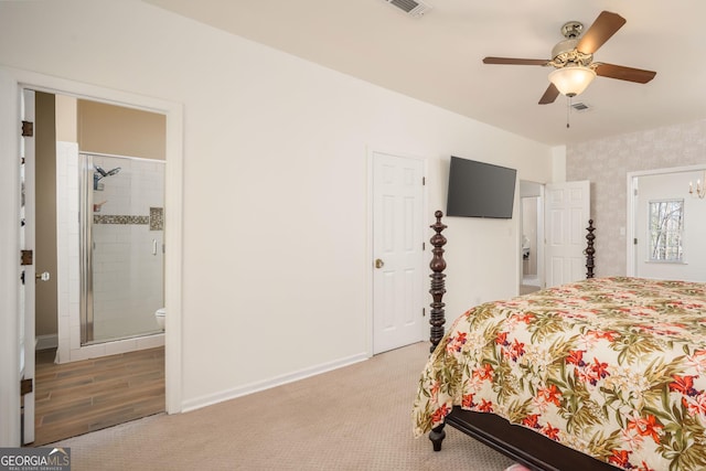 bedroom with visible vents, connected bathroom, wallpapered walls, baseboards, and light colored carpet