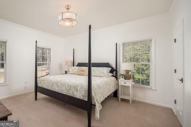 bedroom with baseboards, crown molding, and carpet