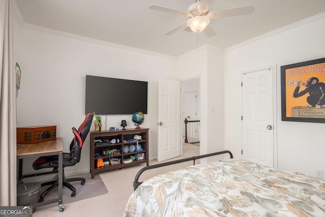 carpeted bedroom featuring ceiling fan, baseboards, and ornamental molding