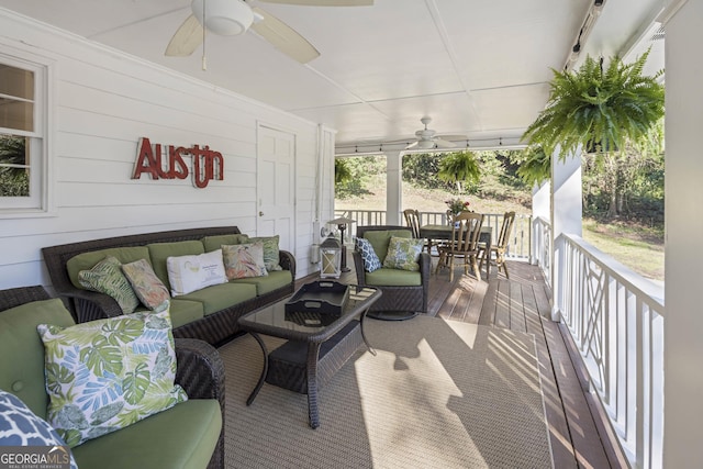 wooden deck featuring an outdoor living space and ceiling fan