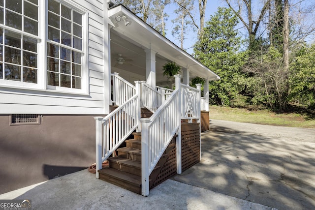view of exterior entry with ceiling fan