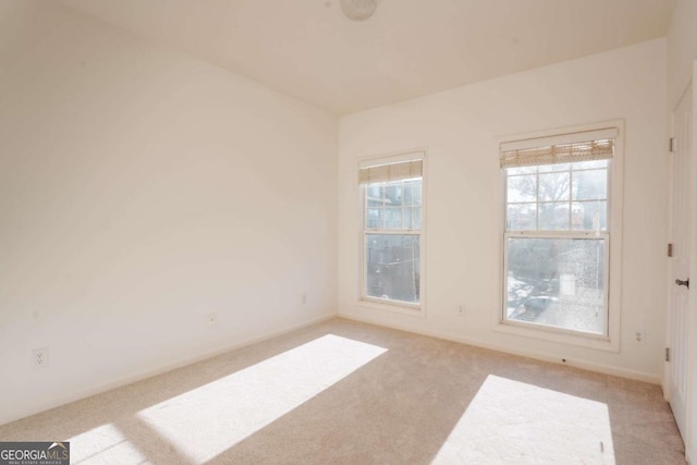 unfurnished room with light colored carpet