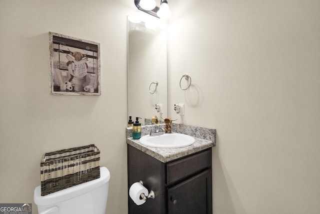 half bath with vanity and toilet