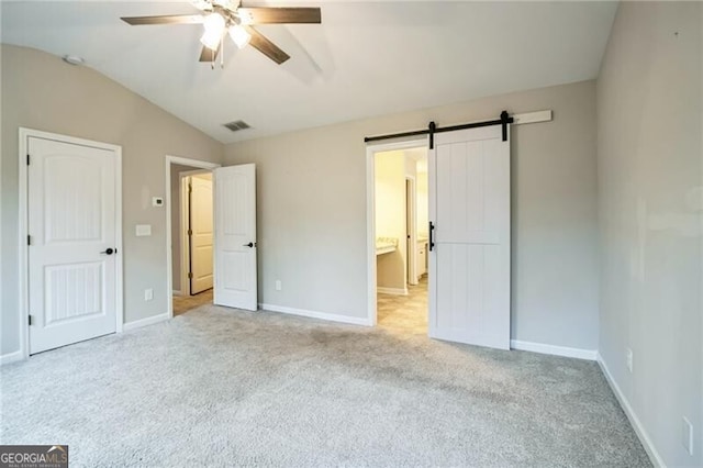 unfurnished bedroom with visible vents, baseboards, light colored carpet, and vaulted ceiling