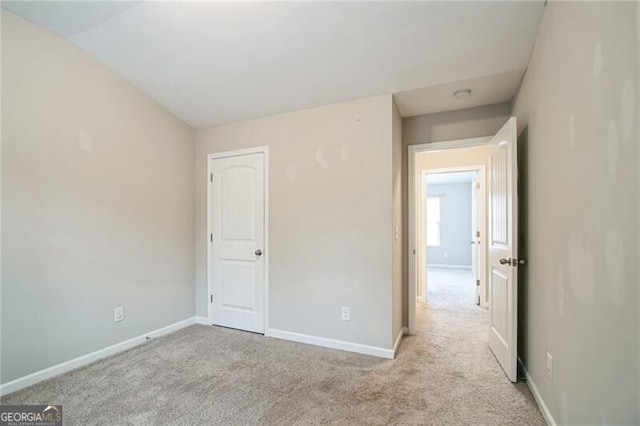 unfurnished bedroom featuring baseboards and carpet floors