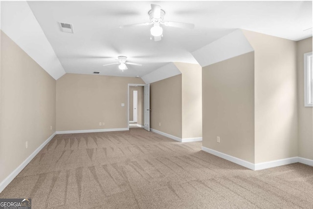 bonus room with vaulted ceiling, carpet, baseboards, and ceiling fan