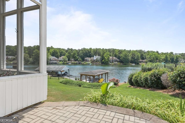 view of patio / terrace with a water view and a boat dock