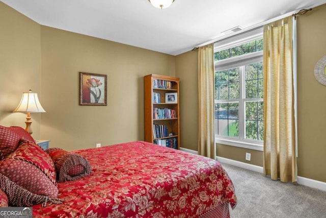 carpeted bedroom featuring baseboards