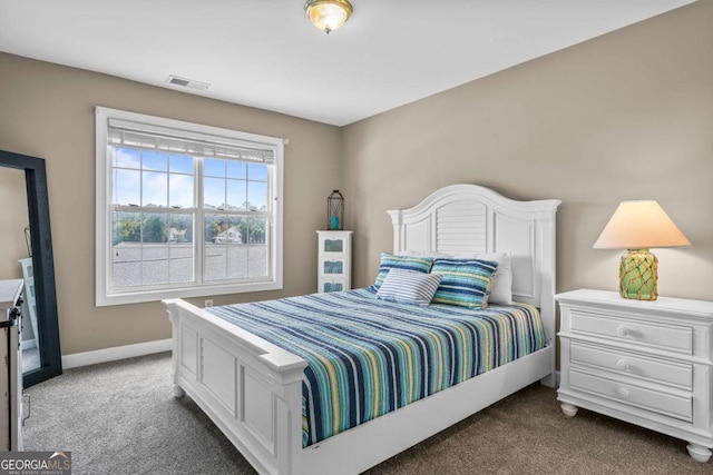 bedroom featuring visible vents, baseboards, and dark carpet