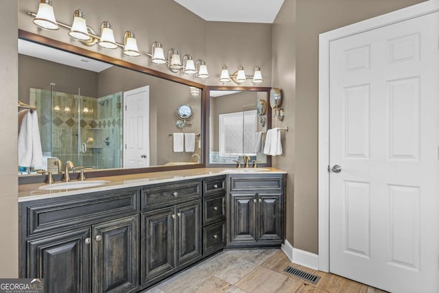 bathroom with a sink, visible vents, double vanity, and a shower stall