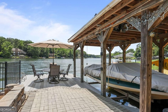 dock area with boat lift and a water view