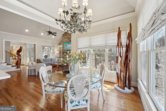 dining area featuring a wealth of natural light, stairway, and ornamental molding