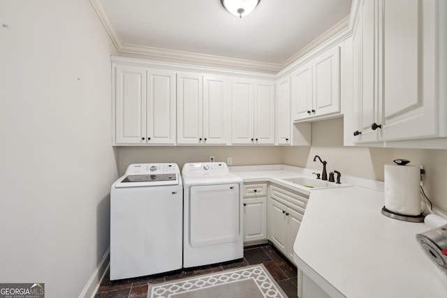 laundry room with cabinet space, ornamental molding, a sink, stone finish floor, and independent washer and dryer