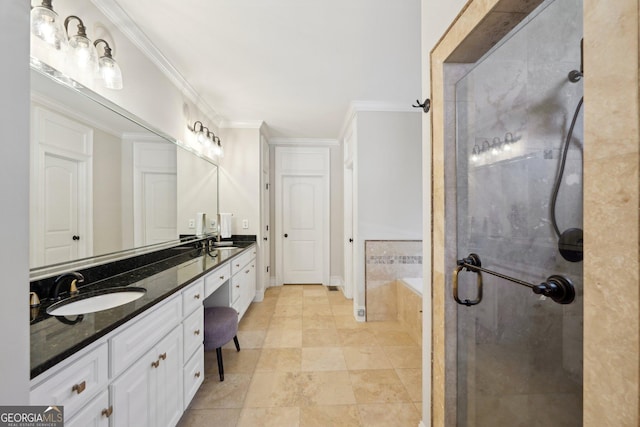 bathroom featuring a shower stall, a garden tub, double vanity, ornamental molding, and a sink