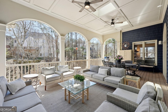 interior space featuring a wealth of natural light, coffered ceiling, and a ceiling fan