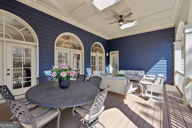 deck with ceiling fan, outdoor dining area, french doors, and an outdoor hangout area