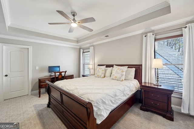 bedroom featuring visible vents, multiple windows, light colored carpet, and a raised ceiling