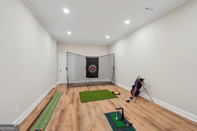 exercise area featuring visible vents, baseboards, wood finished floors, recessed lighting, and golf simulator